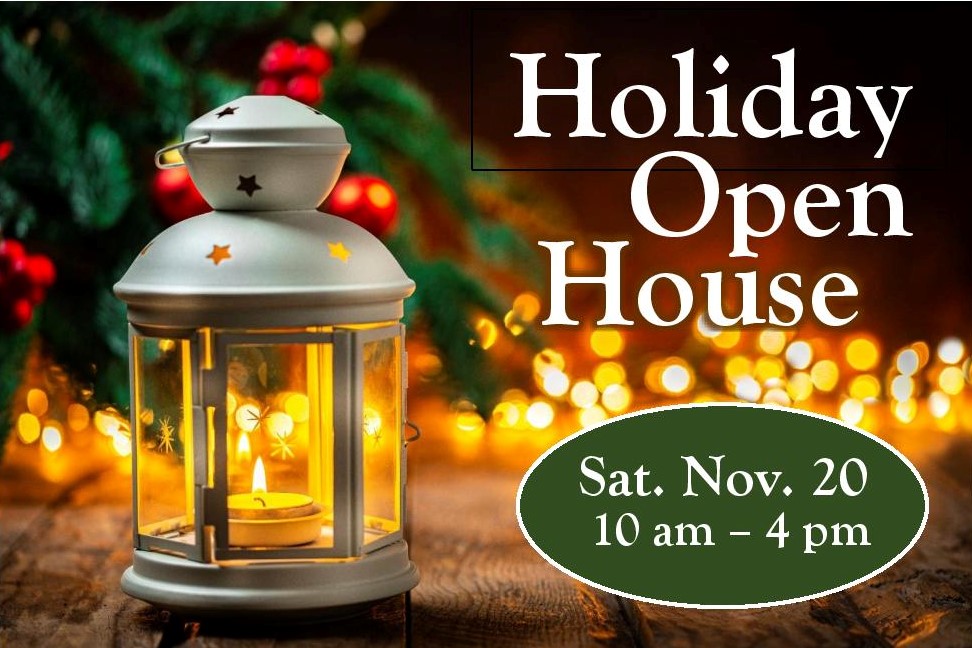 Holiday Open House at Reems Creek Nursery with lantern and bright lights in the distance.