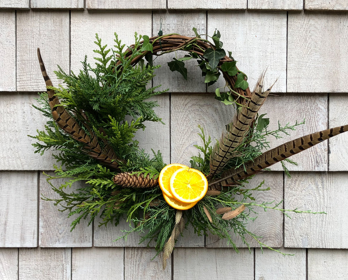Modern Grapevine Wreath with greenery, feathers, and fruit - from Rachel Brownlee